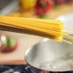 Acqua di cottura della pasta in un contenitore, ideale per innaffiare piante.